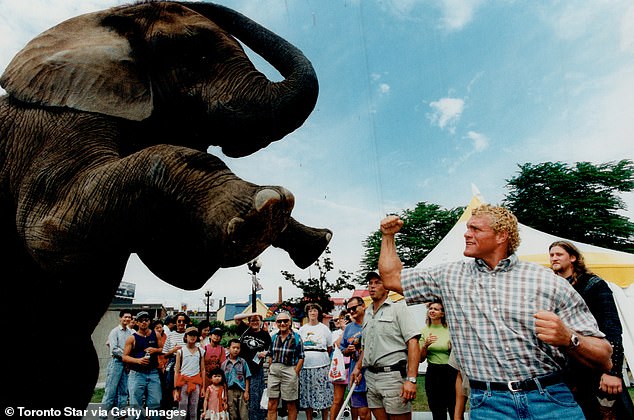 Sid Eudy, also known as 'Sycho Sid', poses with an elephant in Toronto in 1996