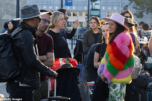 The festival, which combines wilderness camping with a weeklong celebration of art for art's sake, began early Sunday after gates were closed for 12 hours due to rain and muddy conditions.