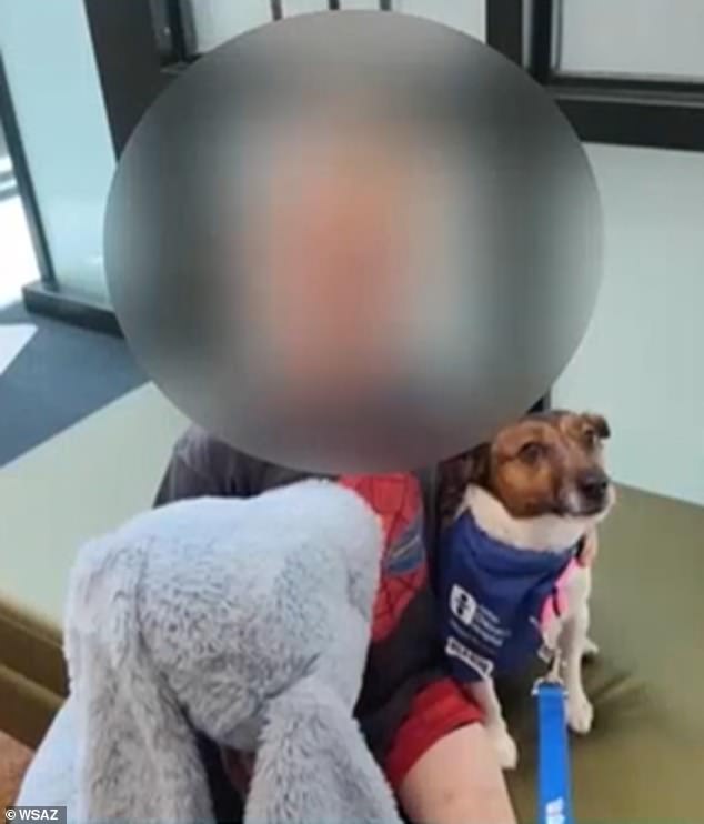 The six-year-old victim, seen here with a different dog, was bitten on the neck and ear and taken to hospital but is expected to recover.