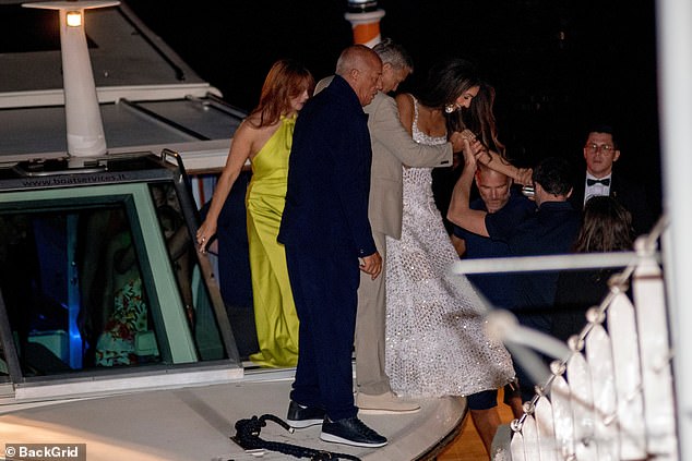 Amal and George were joined by friends as they got off the boat.