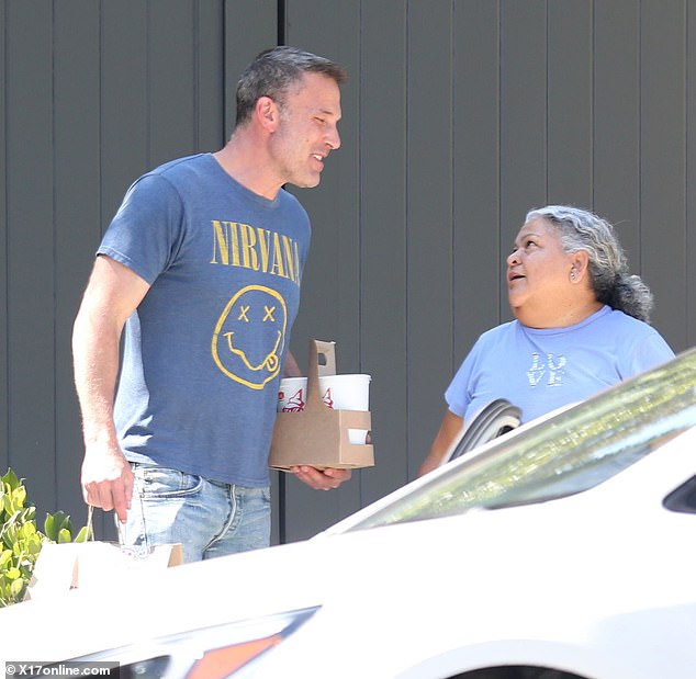 The 52-year-old Argo director flashed a bright smile as he carried the food home, opting to spend his weekend indoors.