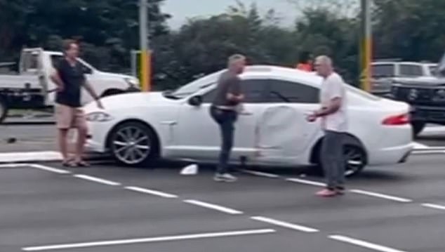 Steve Mace (far left) was one of the witnesses who prevented the alleged attacker (right) from re-entering the car, where the seriously injured man's partner was sitting.