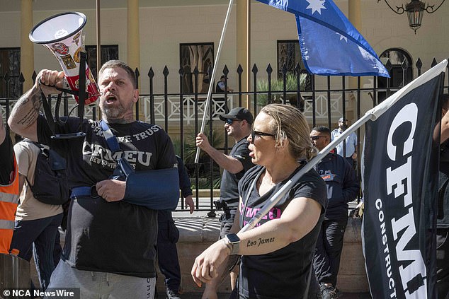 More than a thousand construction workers cheered and applauded former CFMEU NSW secretary Darren Greenfield as he addressed the rally outside state parliament on Tuesday (pictured: protesters in Sydney)