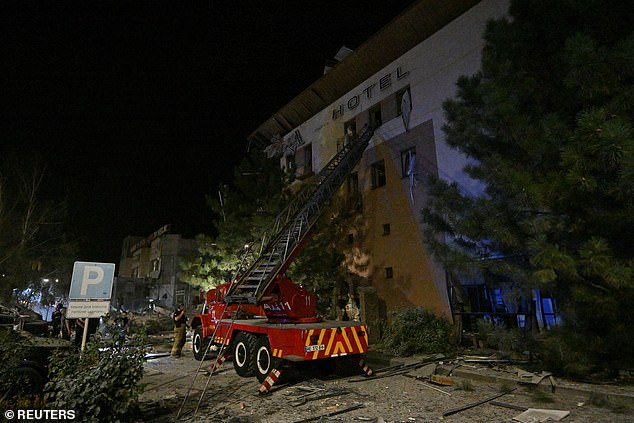 An emergency vehicle is seen next to the building where at least two people died last night