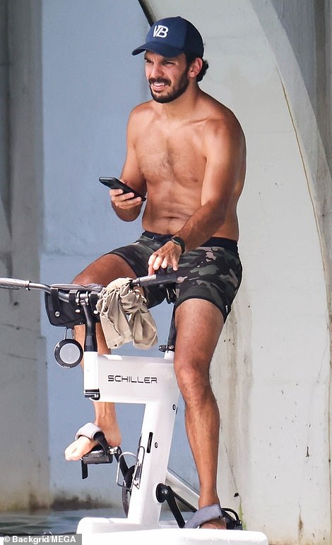 His dark-skinned love interest was shirtless and in just shorts as he took selfies while cycling.