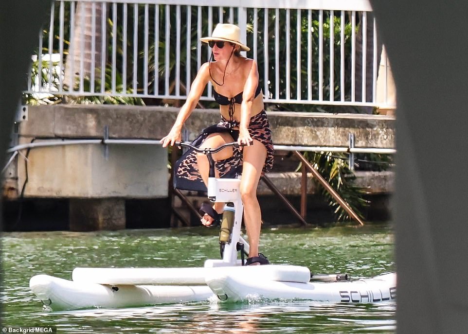 She added a wide-brimmed white hat and strap while wearing cat-eye sunglasses.