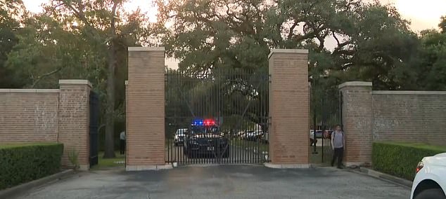 A police vehicle is parked outside the university entrance. There are no signs of forced entry into the hall.