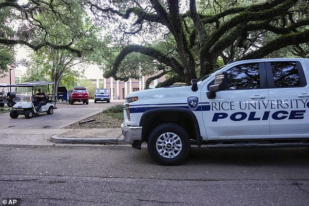 A Rice University police vehicle is parked after the apparent murder-suicide at Jones College