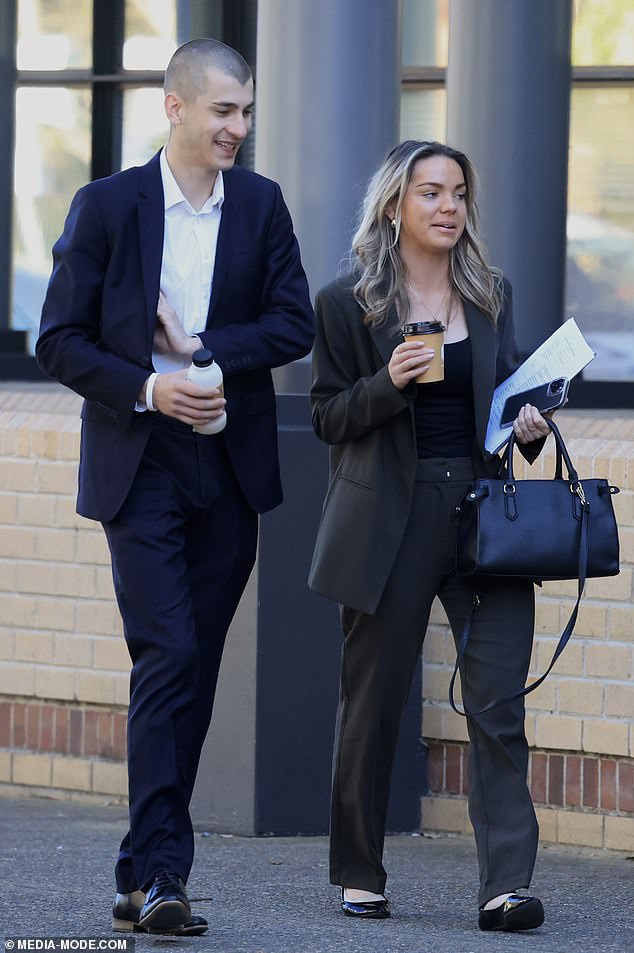 Chris Corrig and his lawyer arrive at Burwood Local Court on Tuesday, where his bail was modified on charges including reciting a Nazi swastika on a statue at Macquarie University.