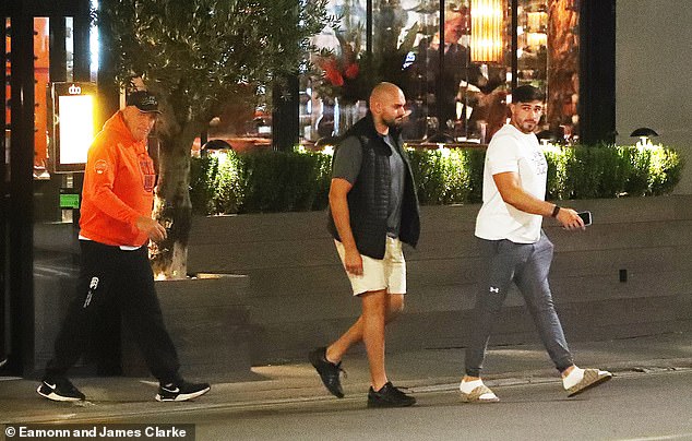 Tommy kept it casual in a white t-shirt, grey sports leggings and Gucci sandals as he walked with his phone in hand.