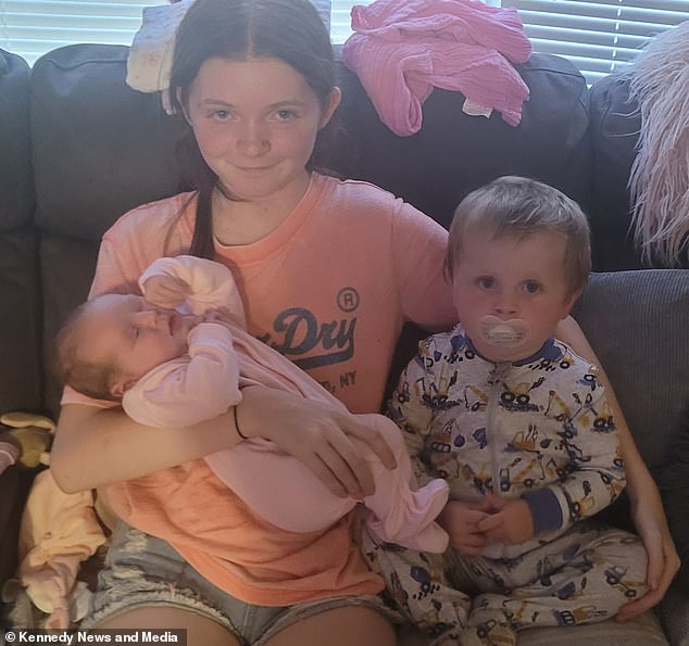 Poppy and Jake are pictured with their new baby sister Hayley, who was born during their family camping holiday.