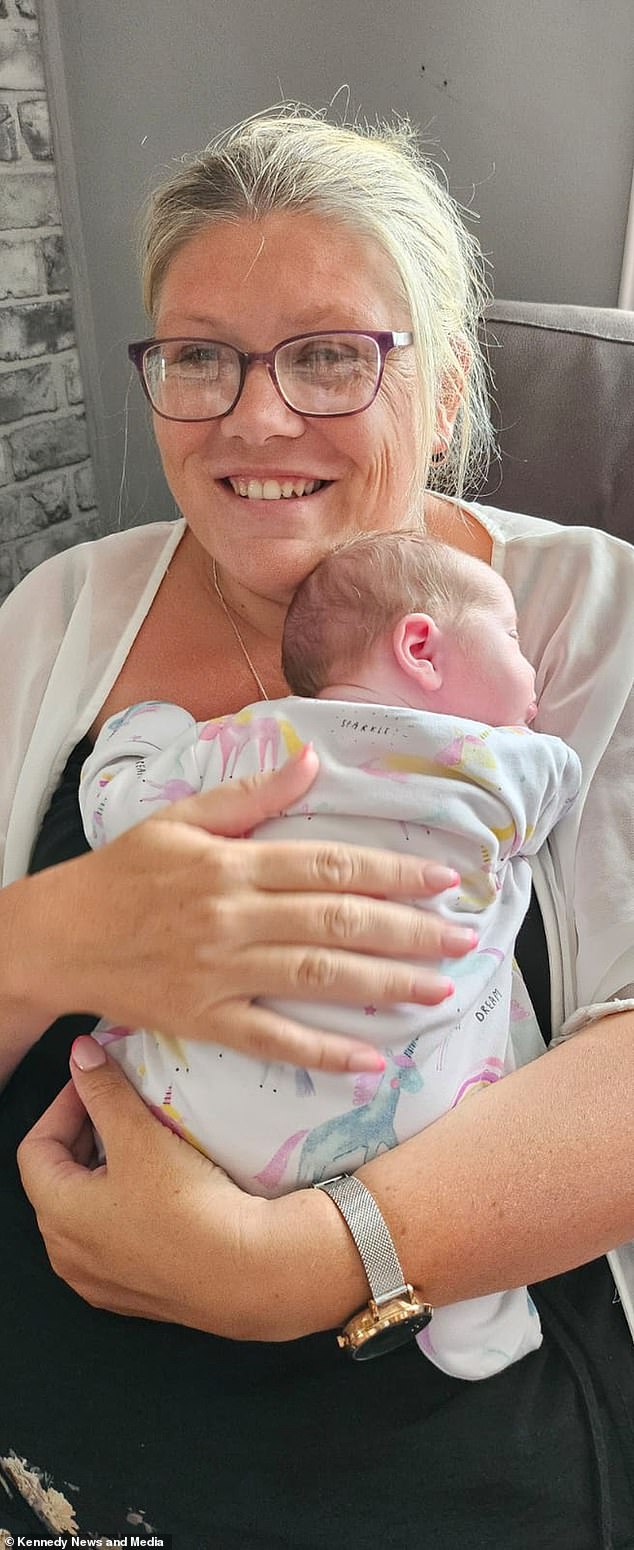 Zoe is pictured holding her newborn daughter Hayley, who surprised the family on August 1.