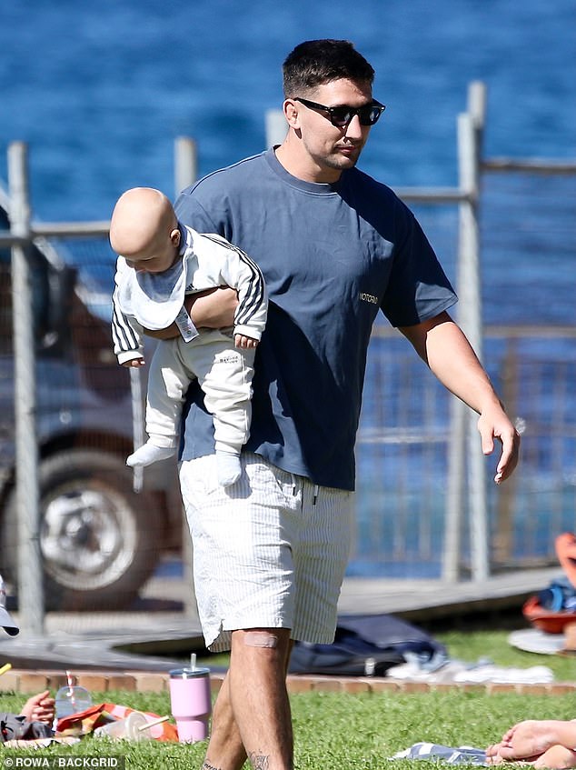 Later that day, Radley changed into a navy blue T-shirt and white shorts.