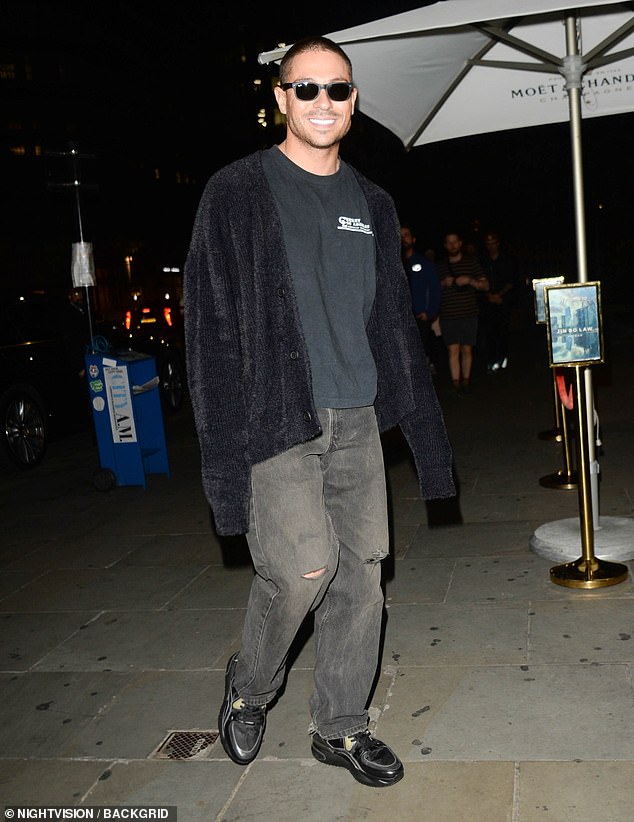 Former TOWIE star Joey opted for a casual look in a pair of faded black jeans, a black T-shirt and an oversized cardigan for the glitzy event in the heart of London.