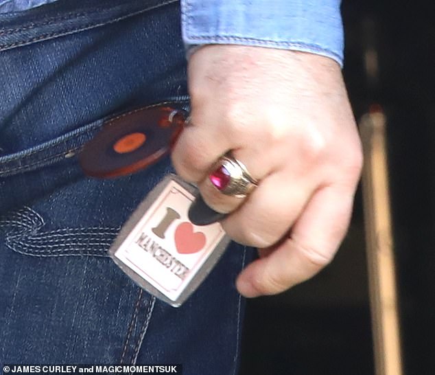 The musician paid tribute to his hometown with an I Love Manchester keyring as he headed into his recording studio in north London on Wednesday.