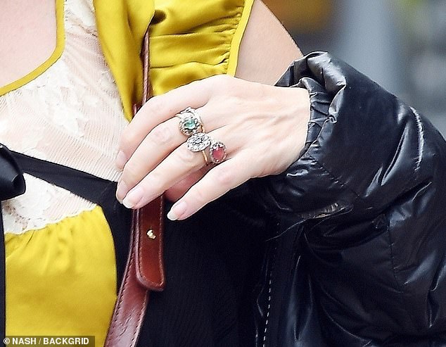 The Harry Potter star accessorised with a long black phone pendant and an array of chunky jewellery, including a sparkling diamond on her ring finger, fuelling speculation that she and boyfriend Rye Dag Holmboe could be engaged.