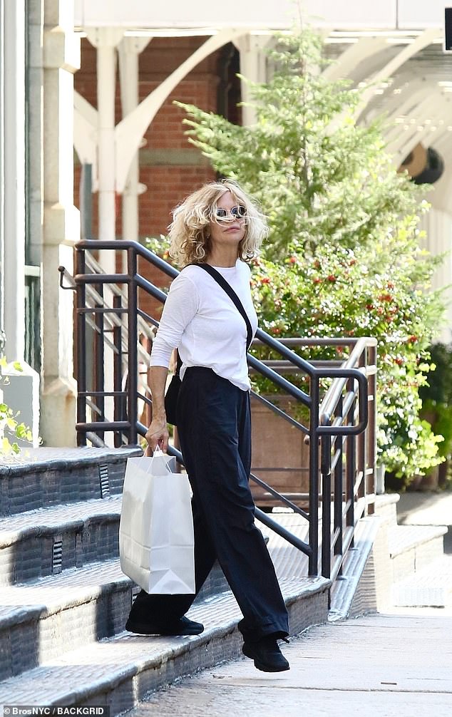 The queen of 90s rom-coms showed off her carefree style in a white cotton blouse, black cargo pants and sneakers.