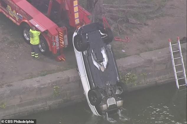 The white Range Rover was finally pulled out of the river at around 9 a.m.