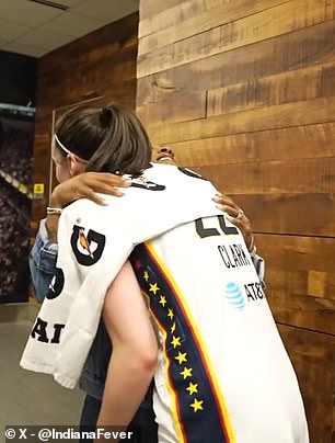 Clark and Biles hug in the Fever locker room