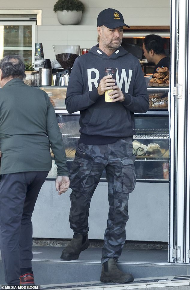 He looked casual in grey camouflage cargo pants and a black hoodie, which he teamed with a pair of chunky Chelsea boots.