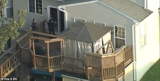 Officers search the contents of the house and are at the back of the house.