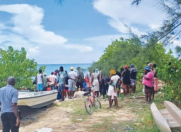 Residents of the town of Falmouth gathered on the beach as the body was recovered.