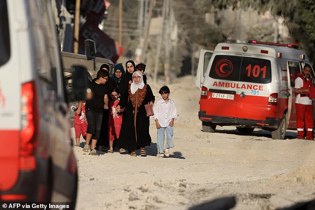 Members of a Palestinian family flee an Israeli raid in the Nur Shams camp near the town of Tulkarem