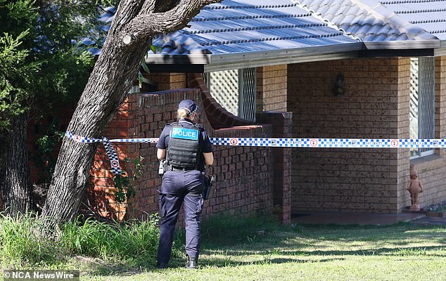 Police are pictured on the corner of Kentville St and Karravin Street.