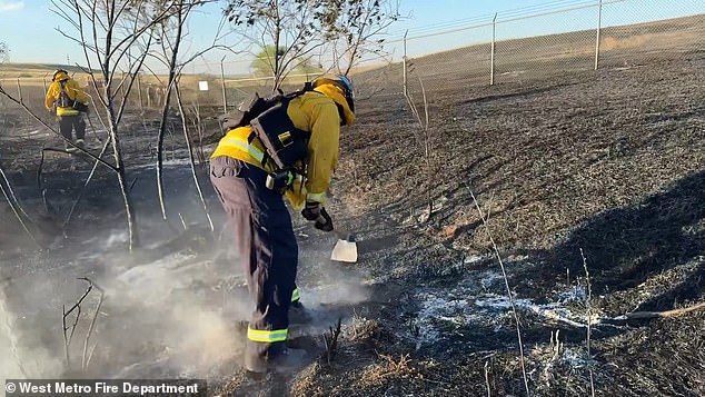 After the fire was contained and the evacuation was lifted, officials warned that residents might still see smoke because small areas of vegetation could be burning.