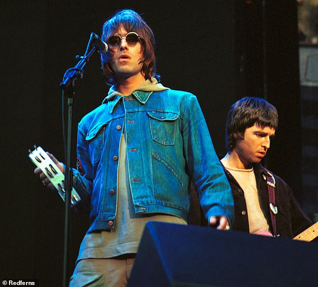 Liam and Noel Gallagher perform to a packed crowd at Wembley Stadium in July 2000