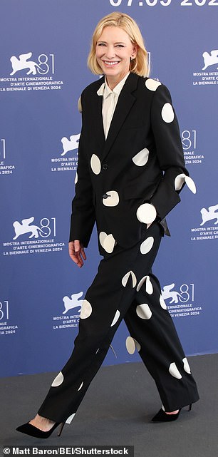 Cate wore a white blouse under her jacket and increased her height with stiletto heels.