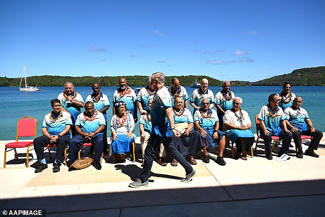 Mr Albanese was caught on camera arriving late for the photo of traditional leaders taken on the final day of the Pacific Islands Forum annual meeting (pictured)