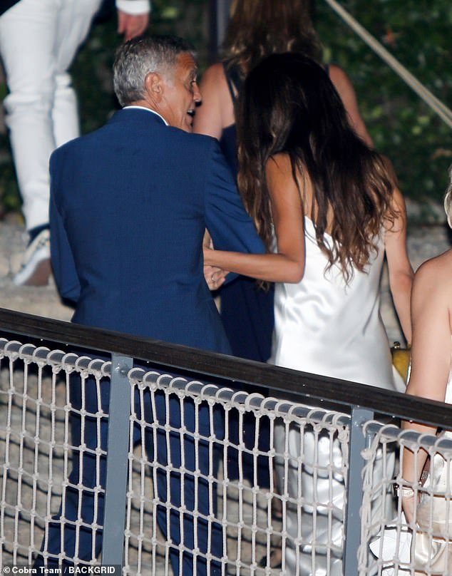 Amal, 46, looked stunning in a white silk dress and flats for the occasion, while George, 63, opted for a tailored blue suit and a white shirt which he left partially unbuttoned.