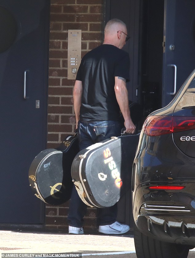 A crew member was photographed carrying two guitars into the studio, complete with a worn case bearing the Oasis logo.