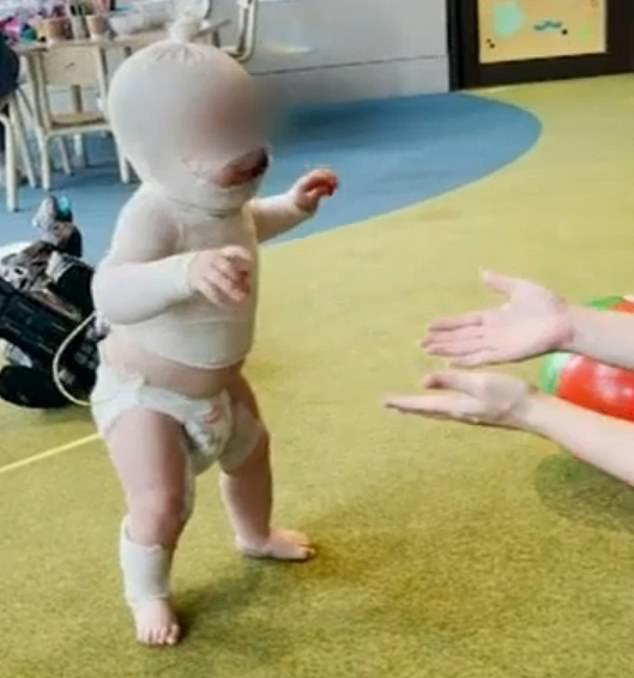 In a positive sign of recovery, Luka's mother shared a video of the baby walking (pictured) and laughing for the first time since Thursday's attack.