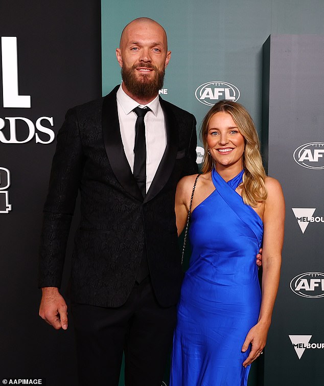 The ruckman was all smiles as his partner stole the show in a royal blue halterneck dress.