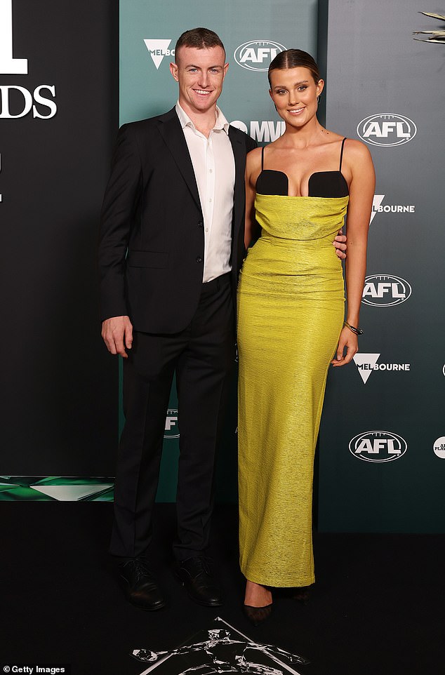 Swans' Chad Warner, 23 (left), was all smiles with partner Alice Hughes (right), who showed off her bust.