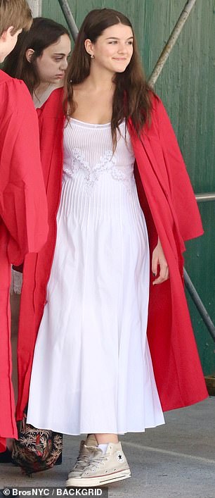 Suri imitated her mother in a white dress with lace details paired with classic Converse sneakers.