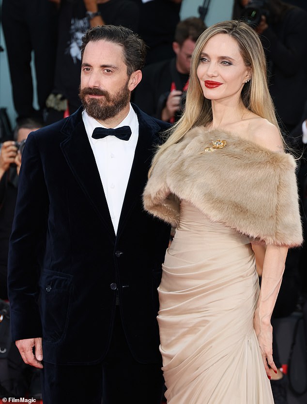 She was photographed being escorted down the stairs by Chilean filmmaker Pablo Larraín, 48, as the crowd continued to applaud her; seen with Pablo on the red carpet.