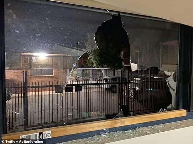 A broken window at an Alice Springs home where huge rocks were thrown through the glass.