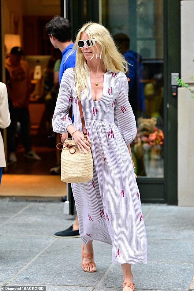 Claudia accessorized her look with a straw bag, white-framed sunglasses, and a pair of brown open-toed sandals.