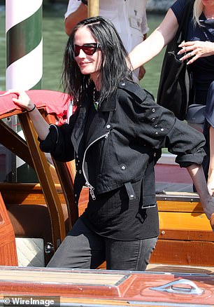 Eva hid behind dark sunglasses and wore a black biker-style jacket, black jeans and a simple black T-shirt.