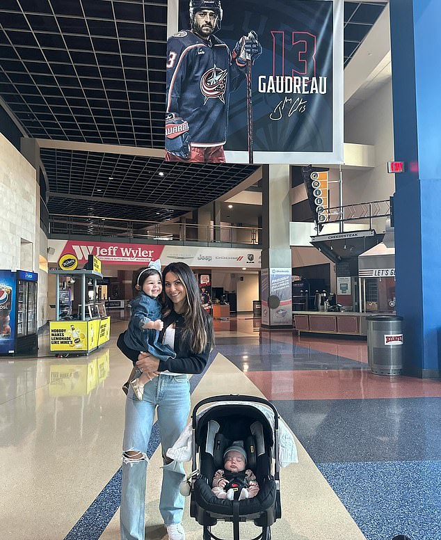 Meredith was also standing beneath a banner with Johnny's photo inside the hockey arena.