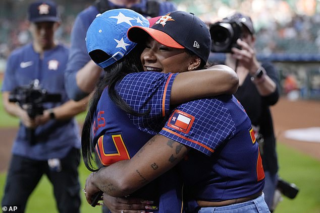 Jordan Chiles, right, hugs fellow Olympic gymnast Simone Biles before Friday's match