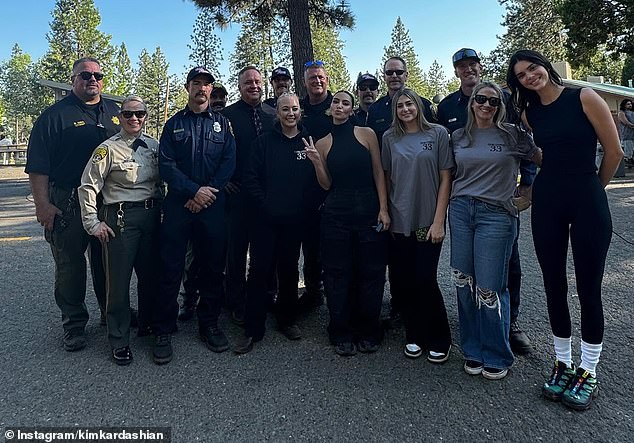 As part of her carousel, Kardashian included a photo of herself standing in the middle of a group of professionals who coach the youngsters in the program. Jenner was seen standing on the far right, towering over the others with her supermodel height.