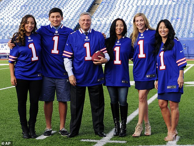 Pegula, left, is seen with her family after her parents Terry (center) and Kim (right) purchased the Buffalo Bills in 2014.