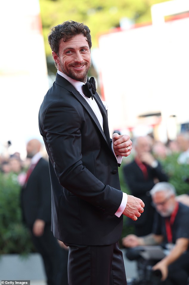 Aaron looked in high spirits as he greeted fans on the red carpet.