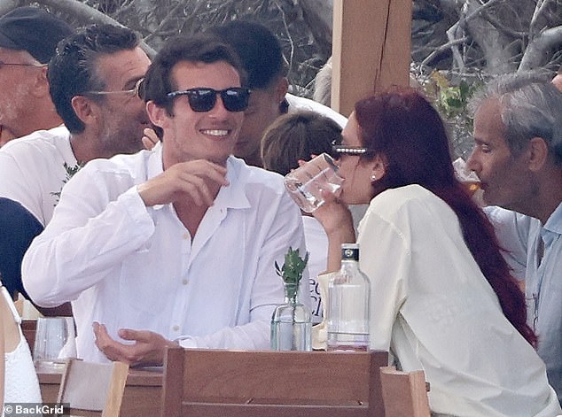 She accessorized her look with a pair of dark sunglasses and wore dark oval sunglasses as she sipped on a drink and enjoyed a bite to eat.