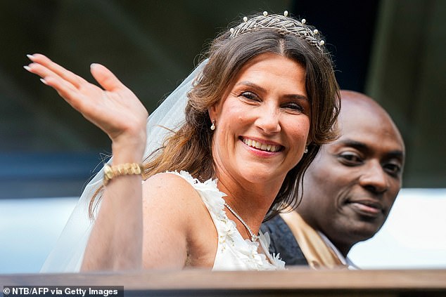 Princess Martha looks stunning in her tiara and veil as she waves to the crowd.