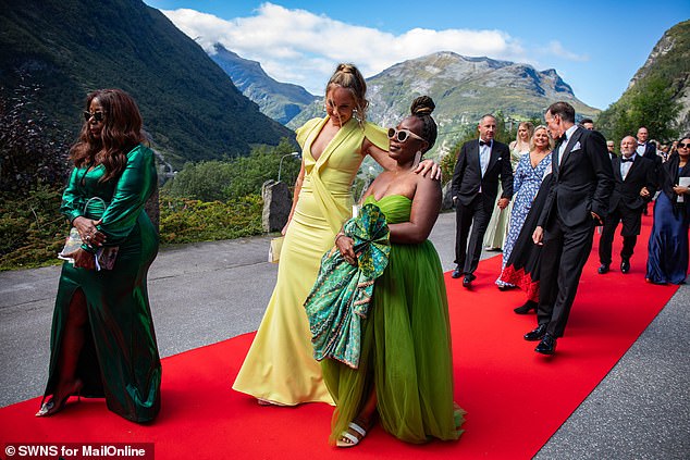 Wedding guests rock glamorous gowns as they walk the red carpet